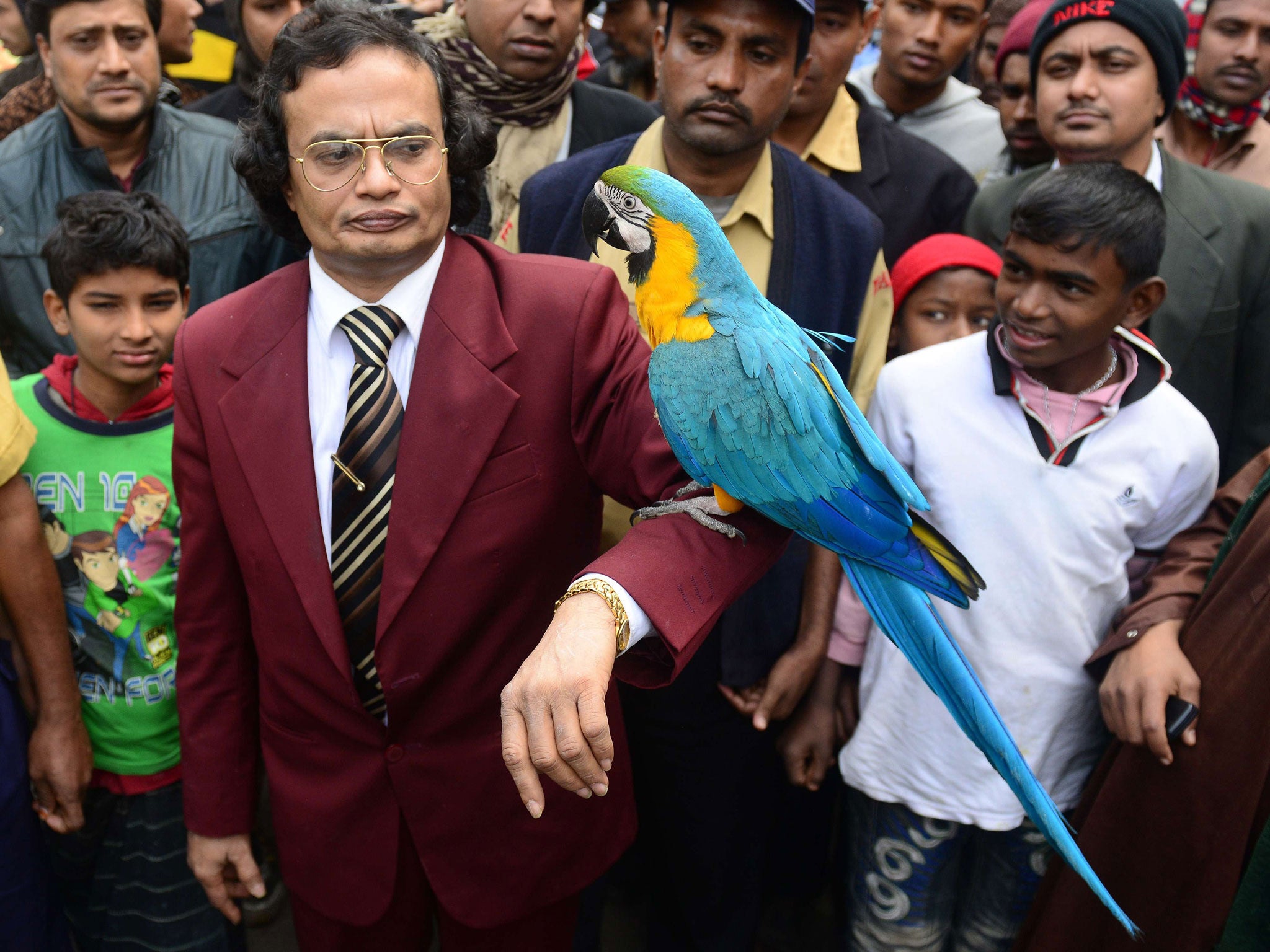 Parrot owner Abdul Wadud poses with Princess the macaw, who has refused to eat since being separated from her partner