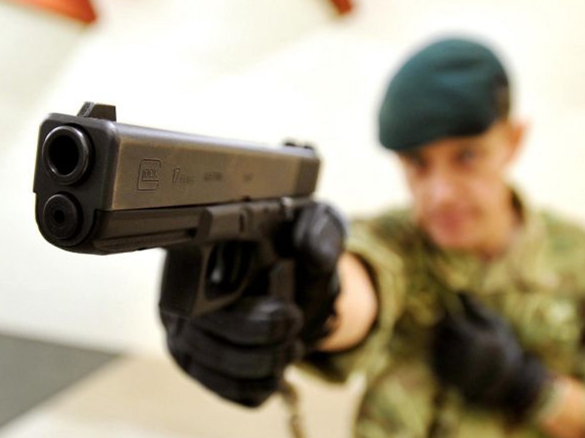 Royal Marine Sergeant Steve Lord tests a Glock 17 9mm pistol, on an indoor shooting range at Woolwich Barracks, south-east London, as personnel from all three services are to start using the new Glock pistols after a contract was awarded to replace the cu