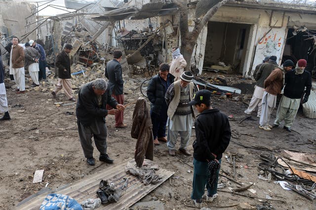 Residents gather at the site of bombings in Quetta