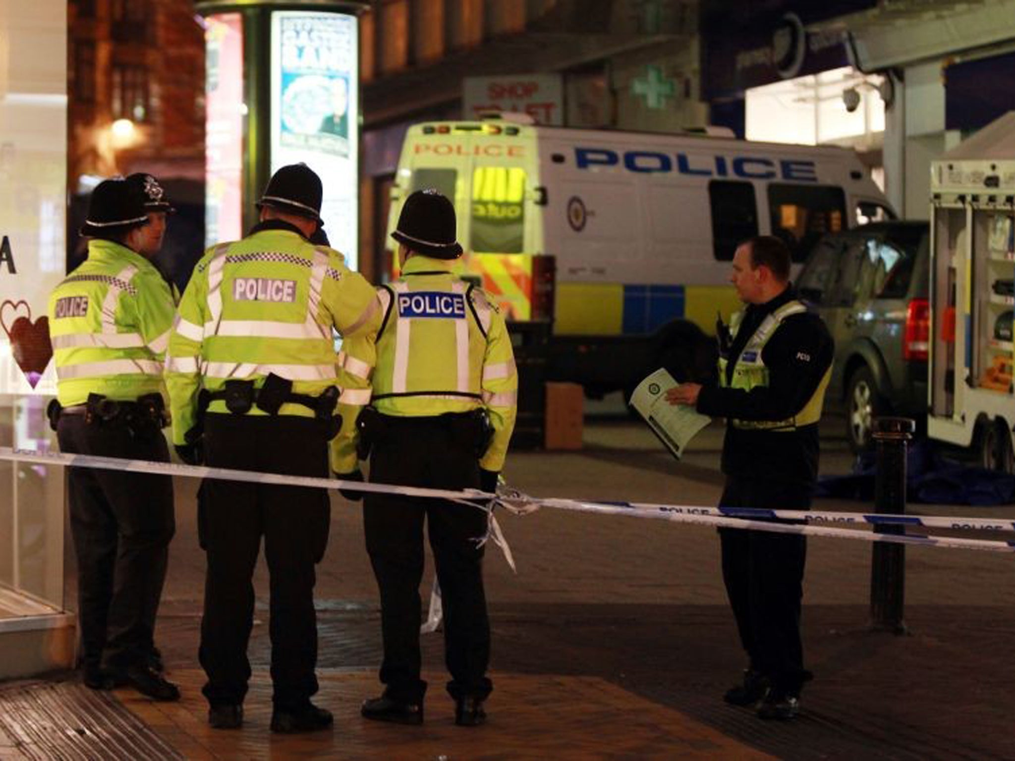 Police at the scene on Union Street in Birmingham city centre after two men were stabbed to death yesterday evening