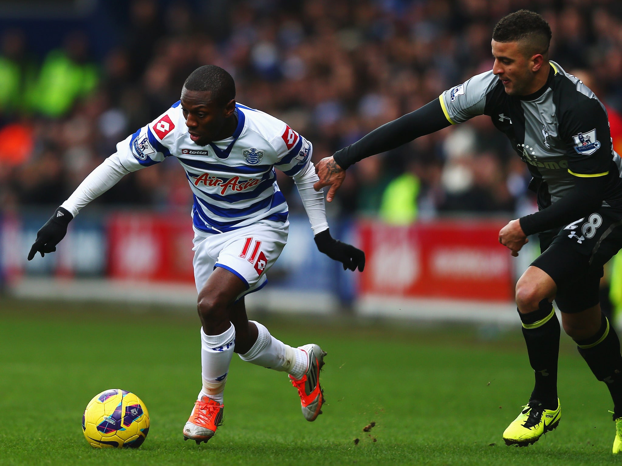 Shaun Wright-Phillips of QPR and Kyle Naughton of Tottenham in action at Loftus Road