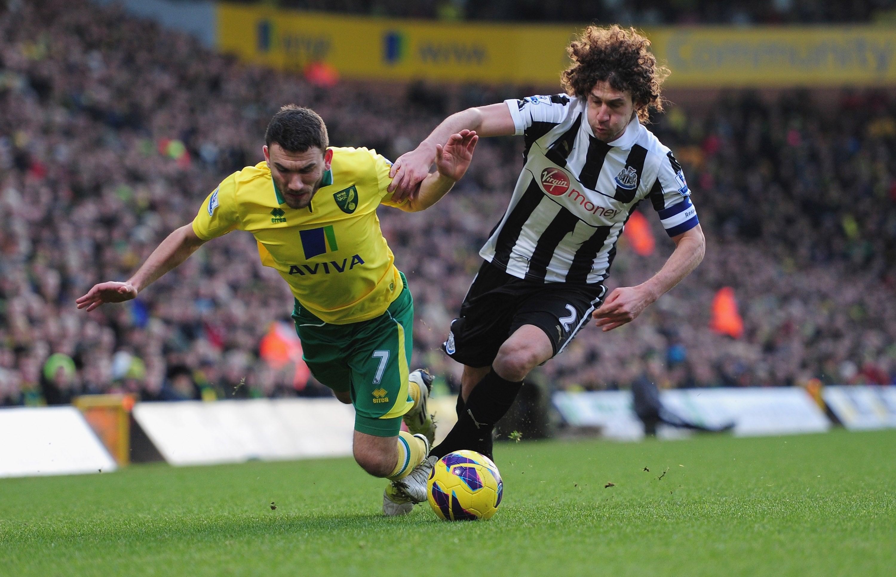 Coloccini and Snodgrass vie for the ball