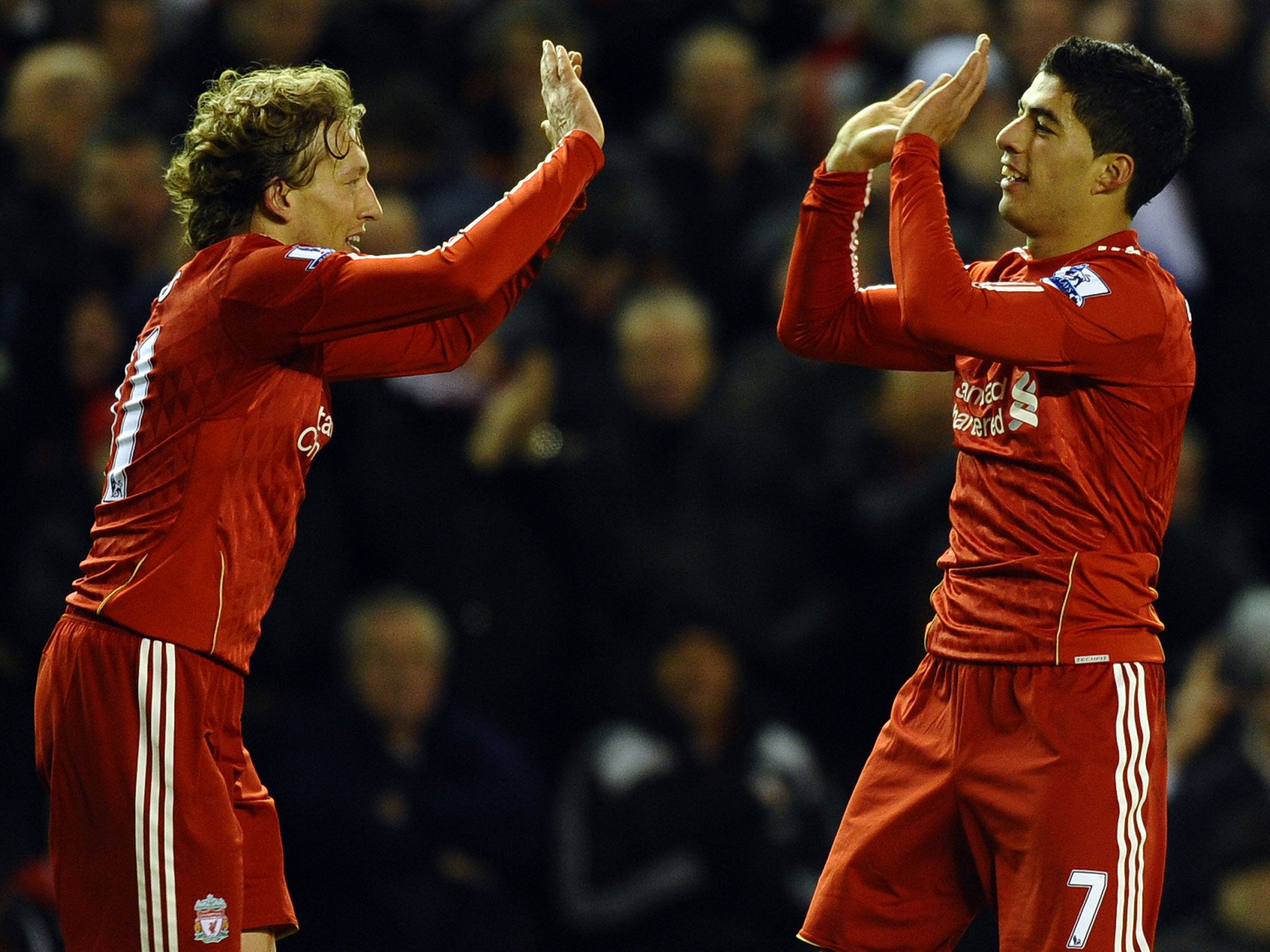 Put it there: Lucas Leiva (left) has established a close bond with Luis Suarez and his family