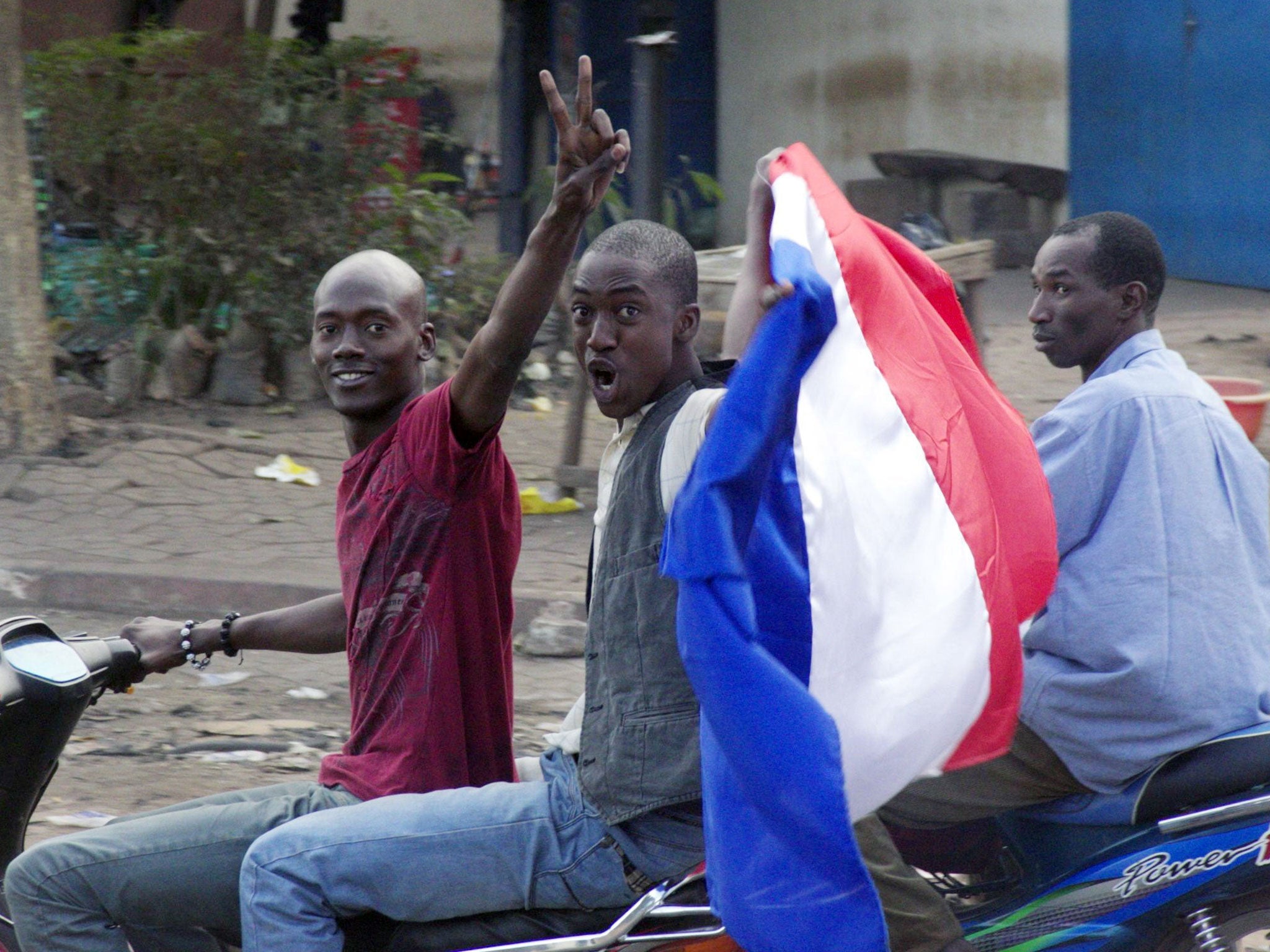Inhabitants of Bamako, the capital of Mali, wave a French flag following the military intervention