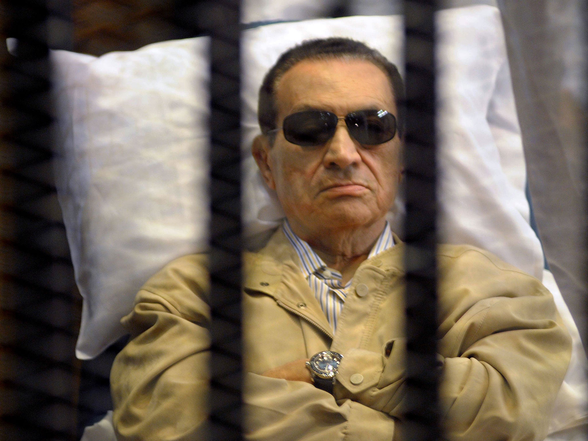 Ousted Egyptian president Hosni Mubarak sits inside a cage in a courtroom during his verdict hearing in Cairo on June 2, 2012. A judge sentenced Mubarak to life in prison after convicting him of involvement in the murder of protesters during the uprising that ousted him last year.