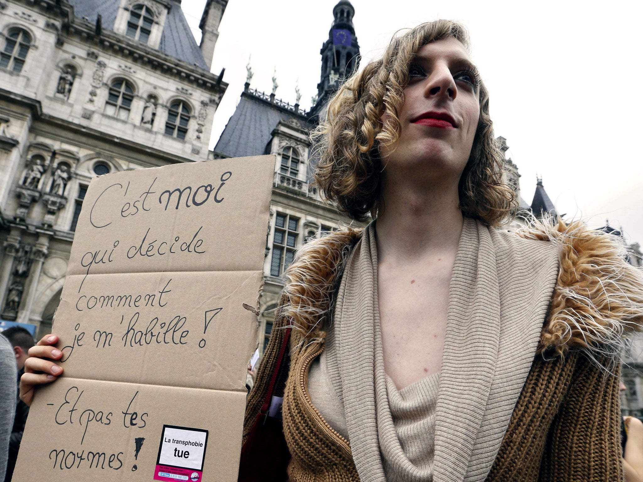 The placard reads 'I am the one who decide how I dress and not your standards'. Photo taken at the 16th Existrans, a parade to fight for the rights of transsexual and transgender people on October 20, 2012 in Paris.