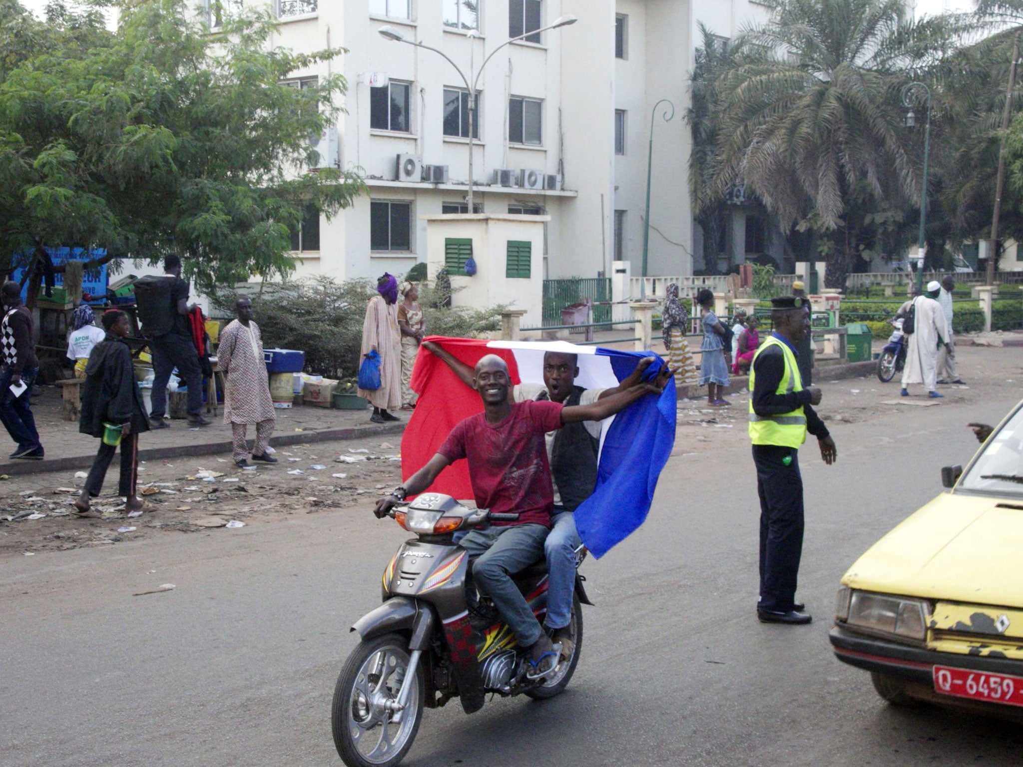 Malian people wave a French national flag on a scooter on January 12, 2013 in Bamako as France sent troops the day before to help Malian forces hold back an advance by Islamist rebels.