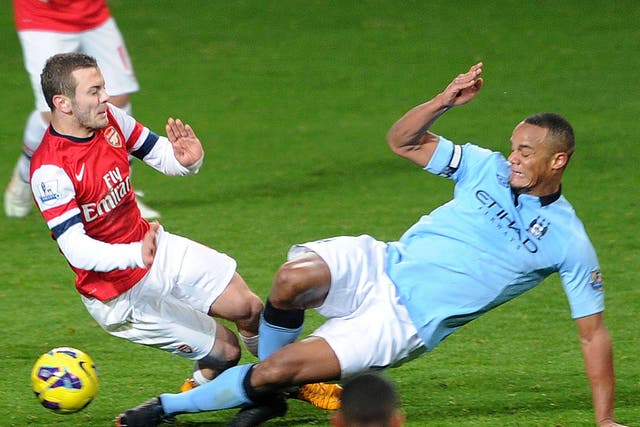 Vincent Kompany makes a challenge on Jack Wilshere which leads to a sending off