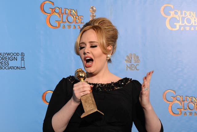 Singer Adele poses in the press room with her best original song in a motion picture award for 'Skyfall' at the Golden Globes awards ceremony in Beverly Hills on January 13, 2013. 