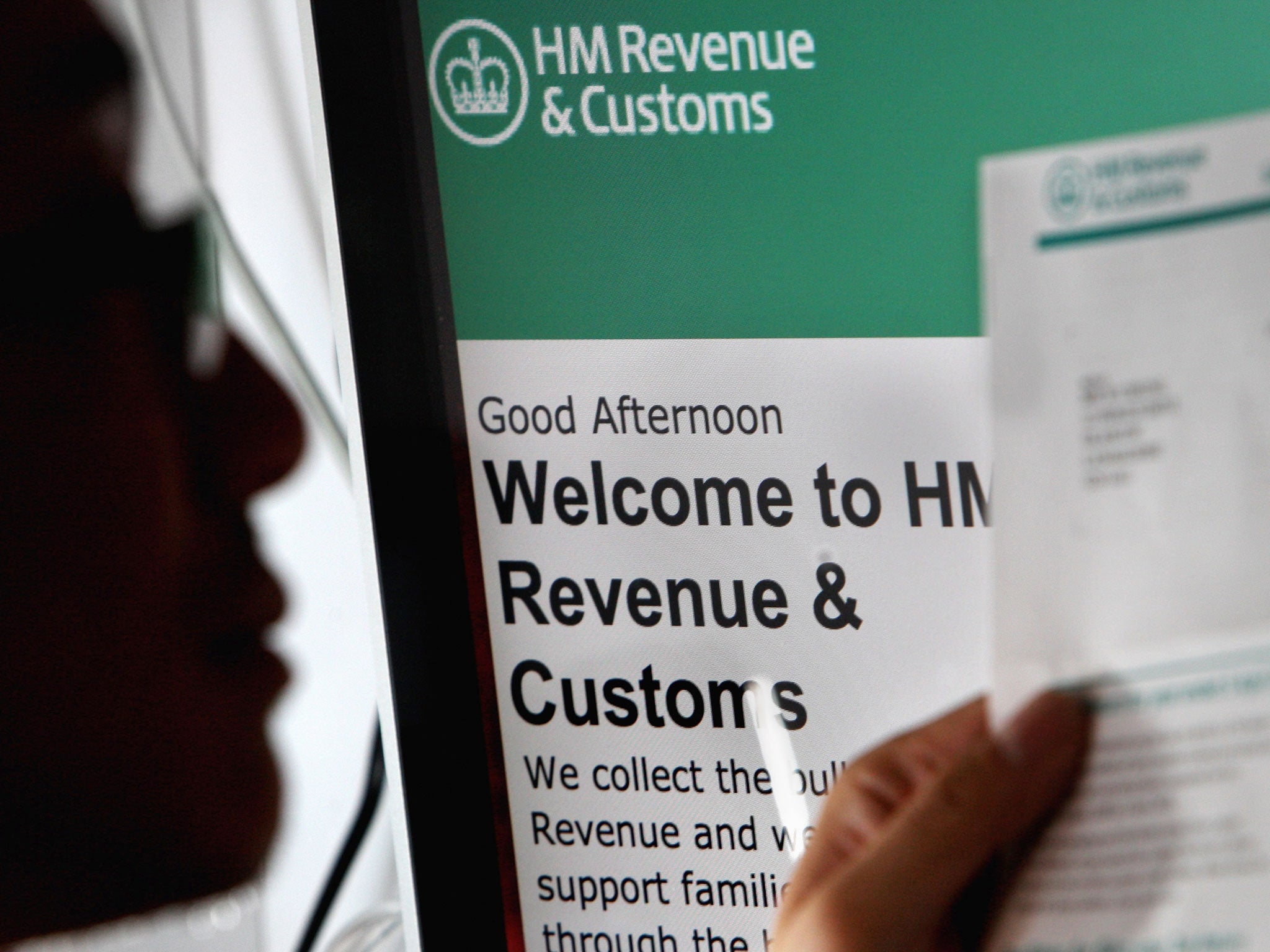 In this photo illustration a man views a tax return form on April 22, 2009 in Glasgow, Scotland.