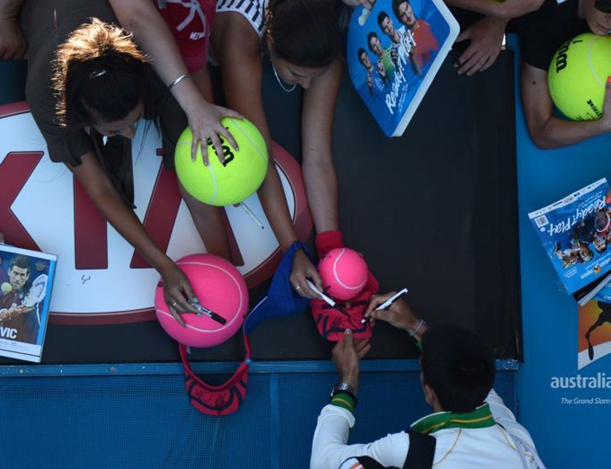 Novak Djokovic signs autographs after his first-round victory in Melbourne