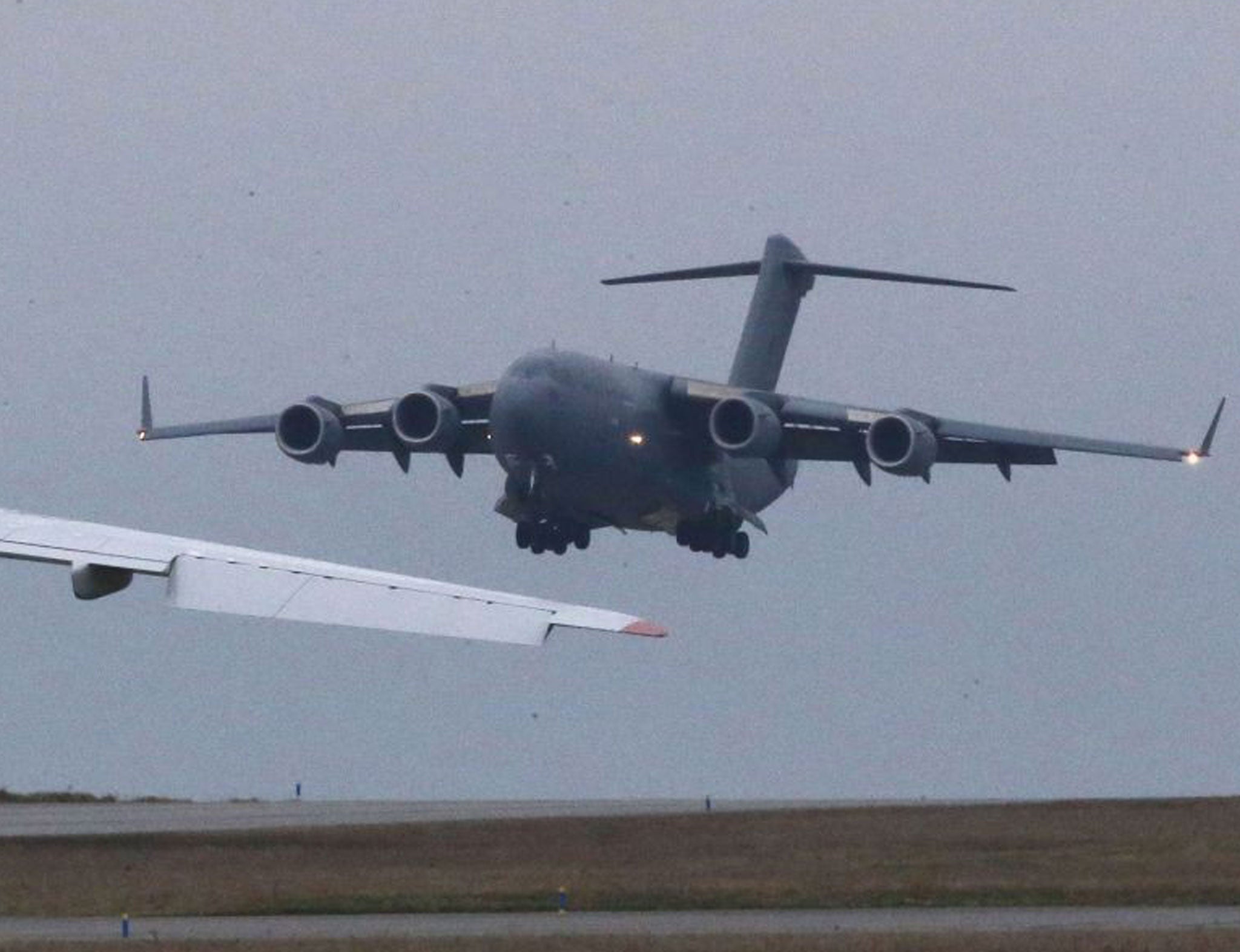 A British transport plane lands next to a Russian Antonov which was hired by the French army to transport equipment to Mali, at the army base in Evreux