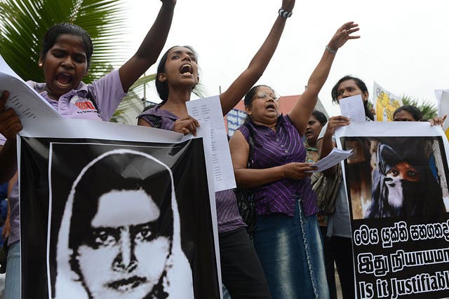 Sri Lankan activists hold up a portrait of Rizana Nafeek as they shout slogans during a protest in Colombo January 11, 2013, following her execution by Saudi authorities. Nafeek, convicted for murdering an infant under her care, was executed by Saudi Arabian authorities on Wednesday despite appeals for clemency from Sri Lankan President Mahinda Rajapaksa.