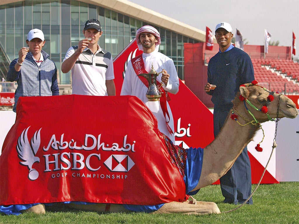 Rory McIlroy (left) joins Tiger Woods (right), Justin Rose (centre) and an Emirati host in a toast to the Abu Dhabi Championship