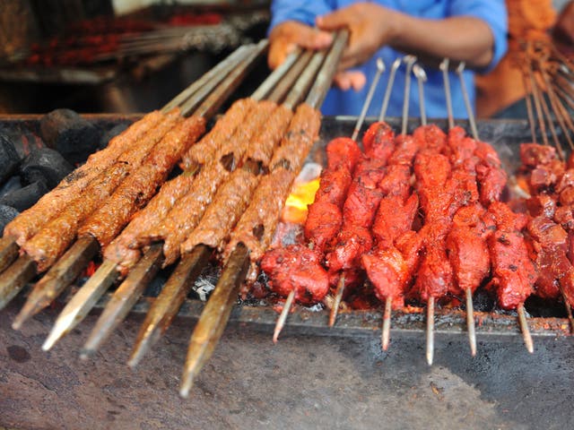 Kebabs are grilled over burning coals on August 19, 2010.