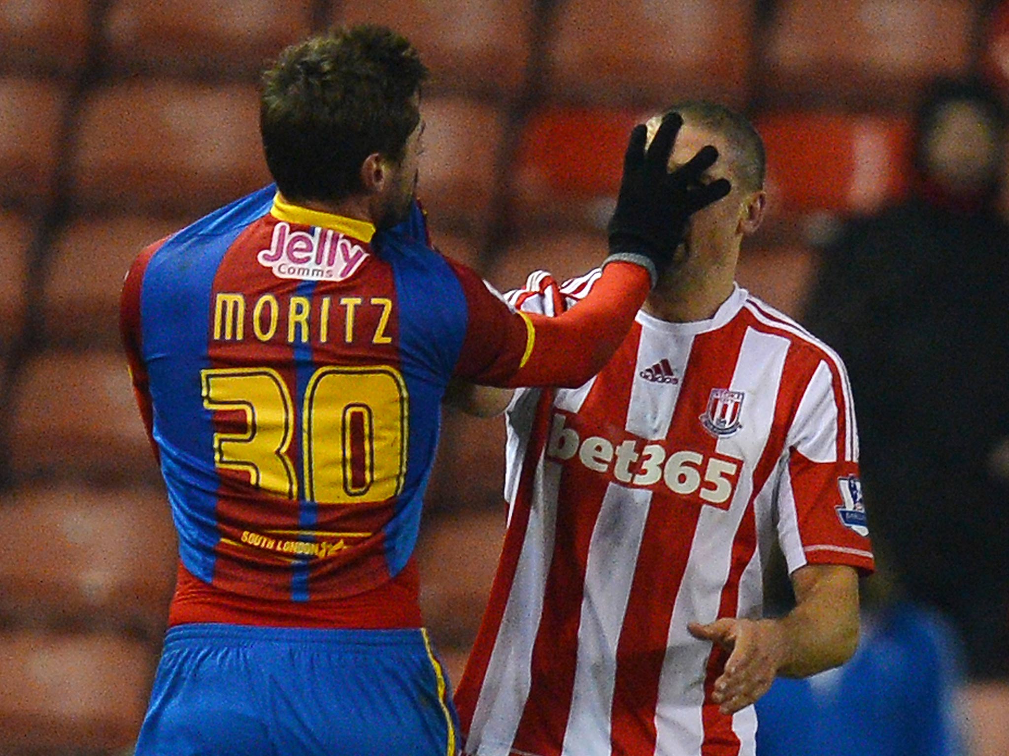 Crystal Palace's midfielder Andre Moritz confronts Stoke City forward Jon Walters