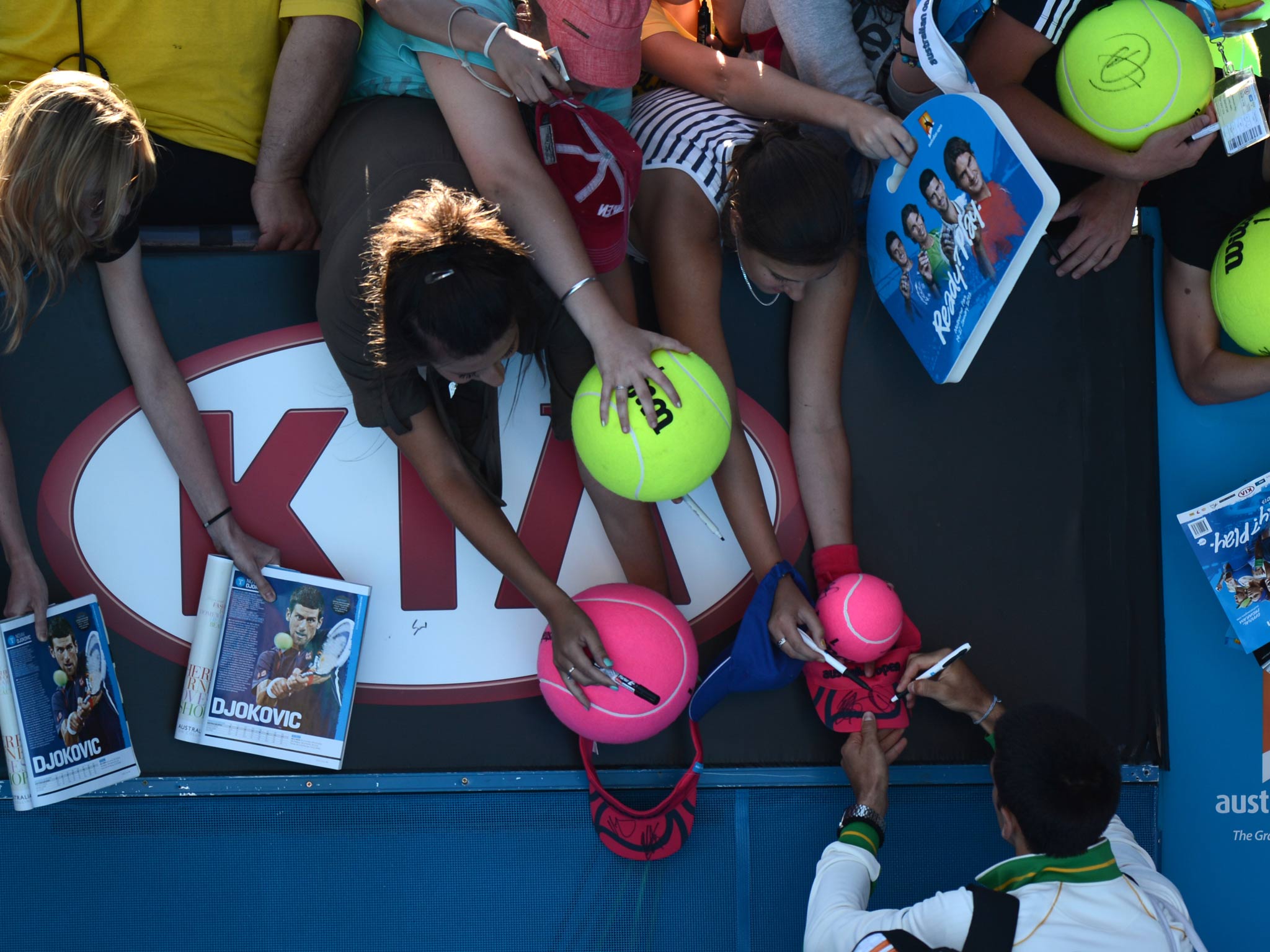 Novak Djokovic signs autographs at the Australian Open