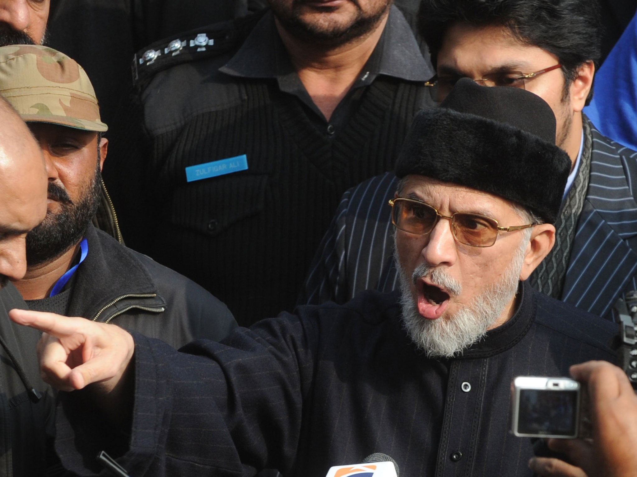 Pakistani religious leader Tahir-ul Qadri talks with media representatives before the start of protest march in Lahore on January 13, 2013.