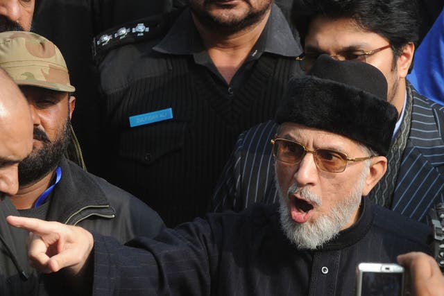 Pakistani religious leader Tahir-ul Qadri talks with media representatives before the start of protest march in Lahore on January 13, 2013.