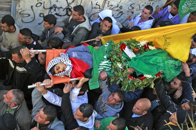Samir Awad’s body is carried for burial on Tuesday