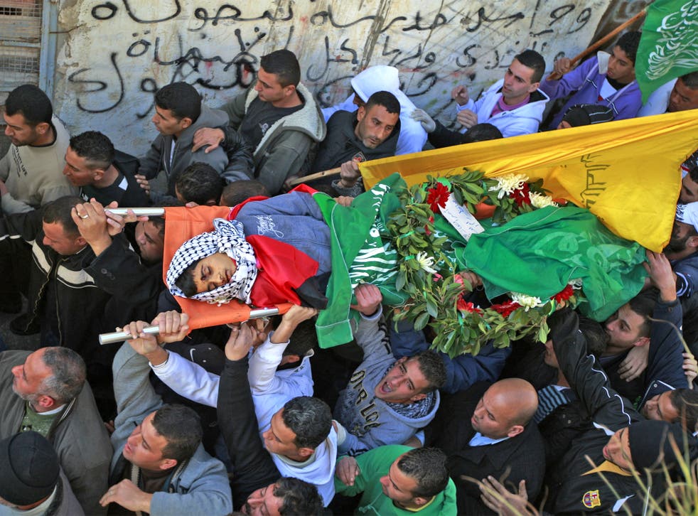 Samir Awad’s body is carried for burial on Tuesday