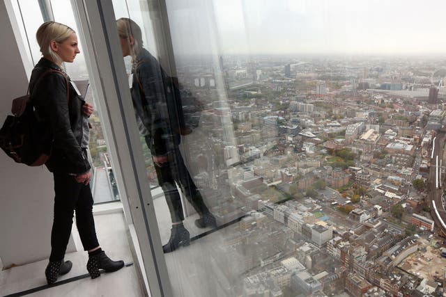 A woman admires the view from the 69th floor of The Shard skyscraper on the preview day to mark the sale of tickets for the 'View from The Shard' experience on October 26, 2012 in London, England.