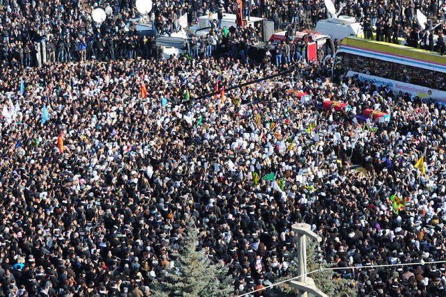 Thousands of Kurds carry the coffins of the three top Kurdish activists Sakine Cansiz, Fidan Dogan and Leyla Soylemez - shot dead in Paris - in Diyarbakir
