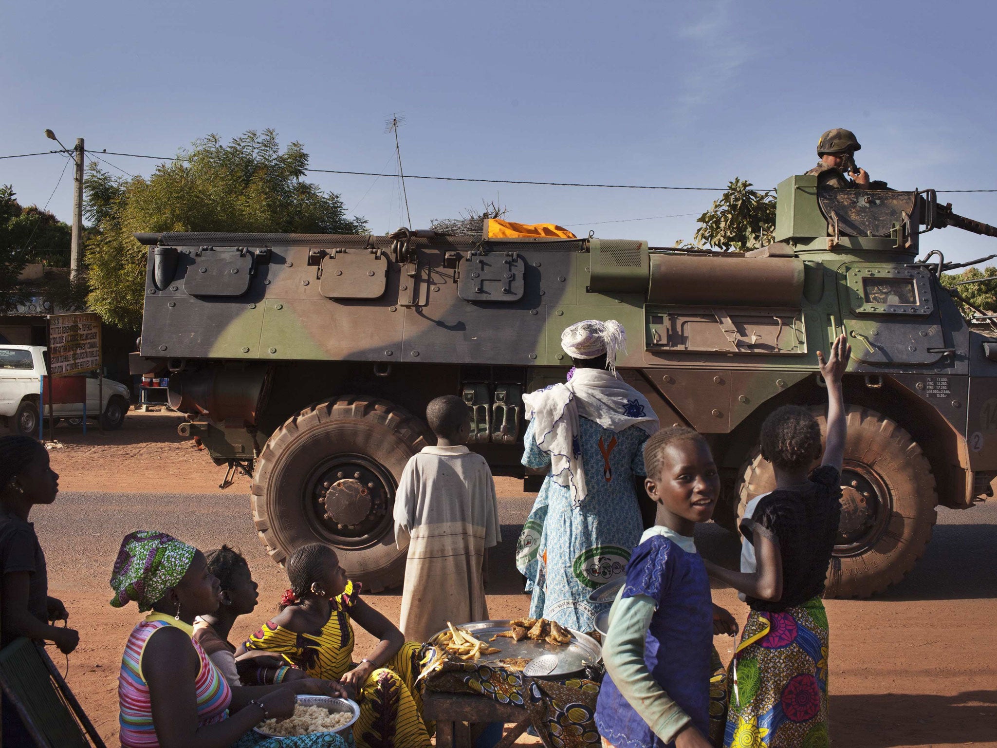 Villagers wave to the French military as they pass through the town of Konobougou, Mali, yesterday
