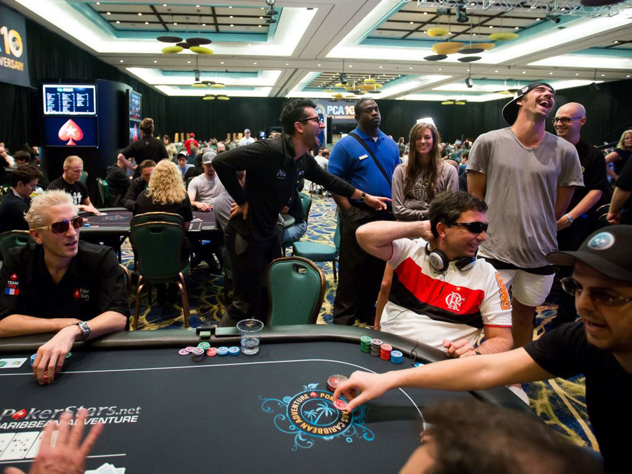 Olympic swimmer Michael Phelps (standing, right) who played at the PokerStars ‘main event'