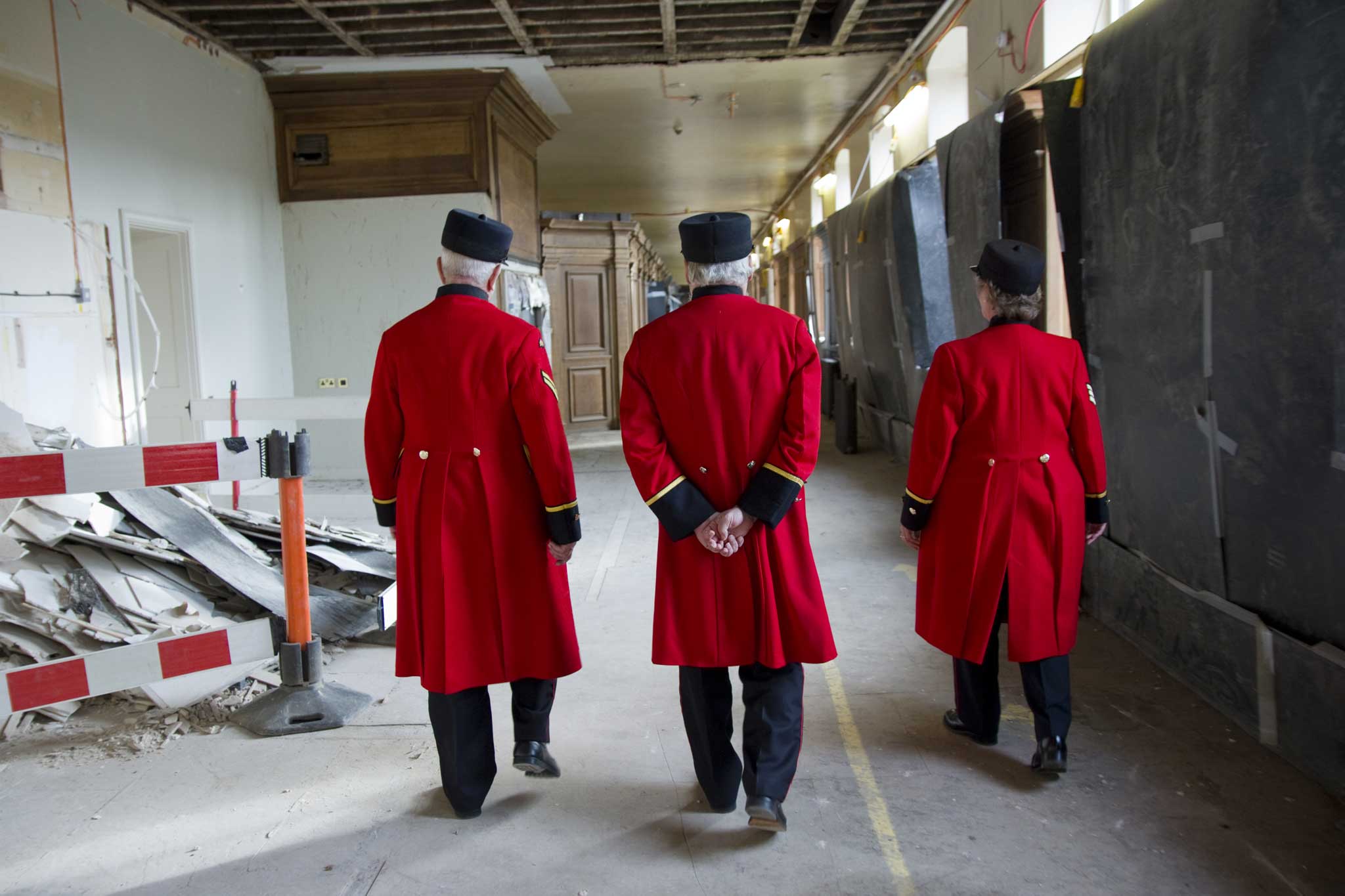 Three current residents of the Royal Hospital stroll through the Long Wards