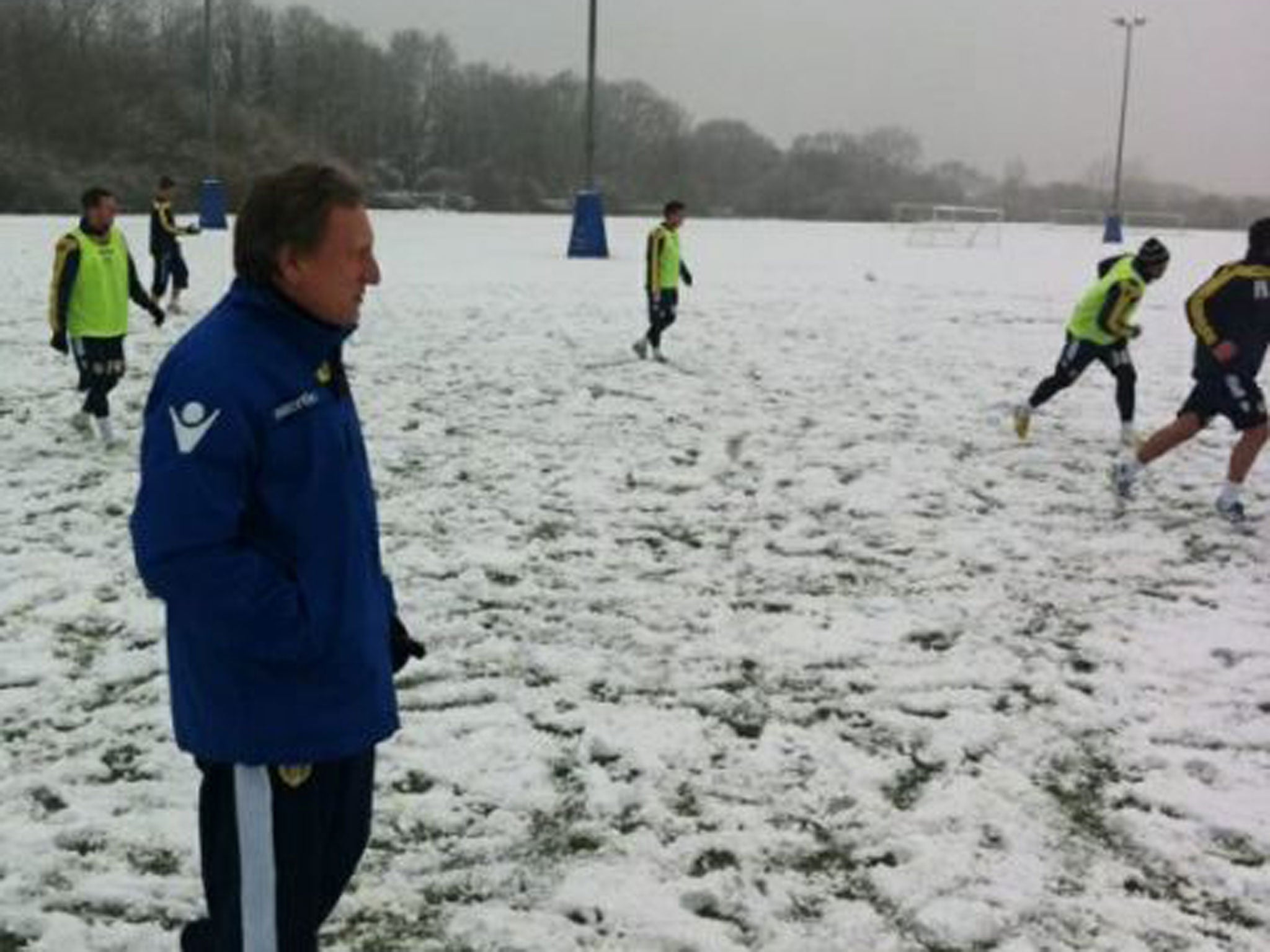 Neil Warnock watches over training during the snow