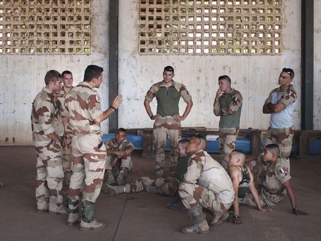 Under orders: French soldiers being instructed at their Malian air base last week