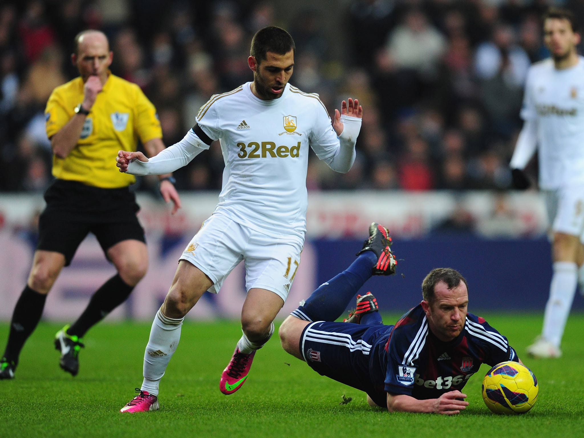 Stoke player Charlie Adam is fouled by Swansea player Itay Schechter