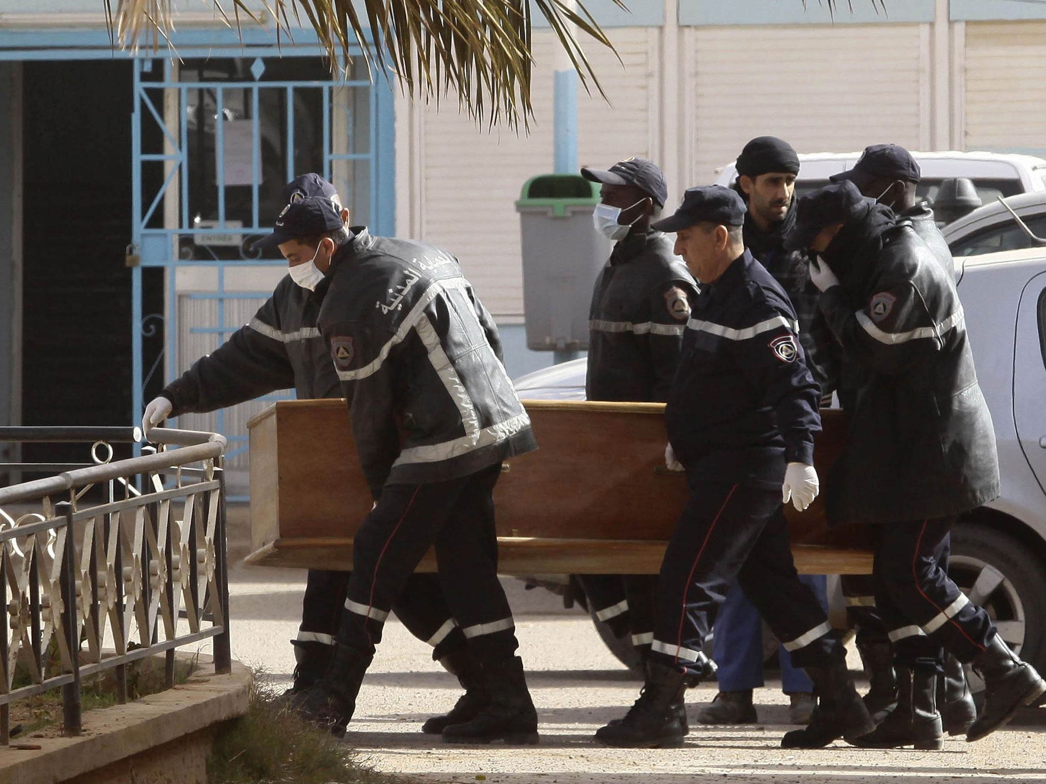 Rescue workers carry the coffin of one of the hostages killed during a hostage crisis in a gas plant at the hospital in In Amenas