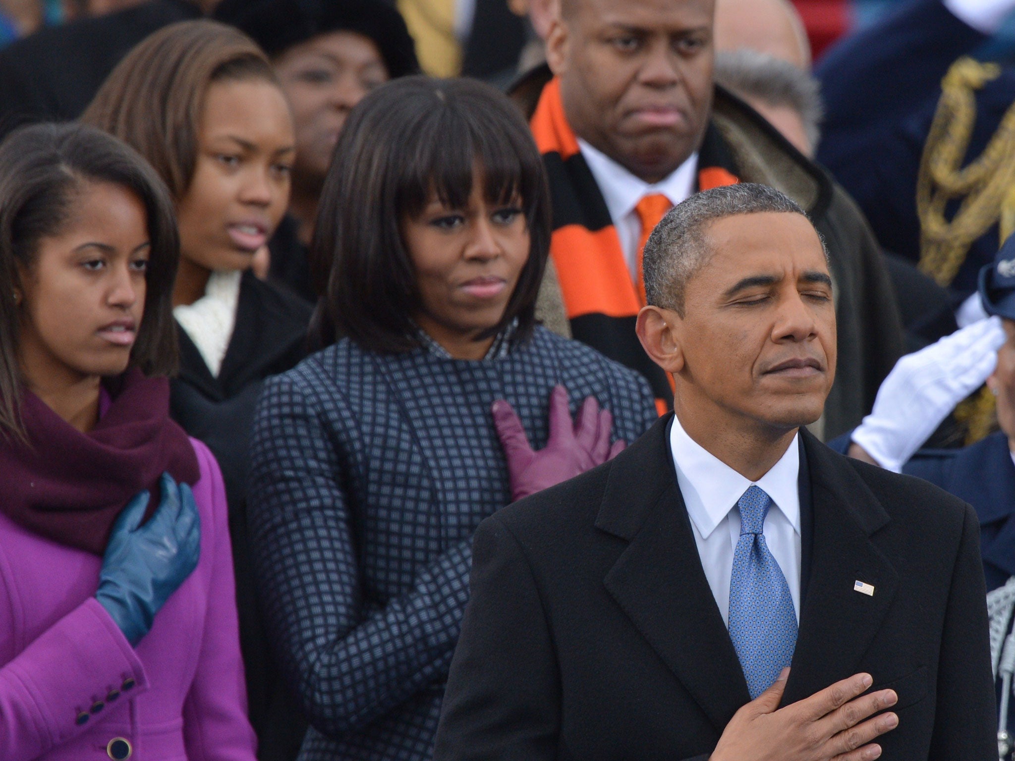 Barack Obama, First Lady Michelle Obama (2nd left) and Malia (left) listen to Beyonce sing during the inauguration ceremonial swearing-in