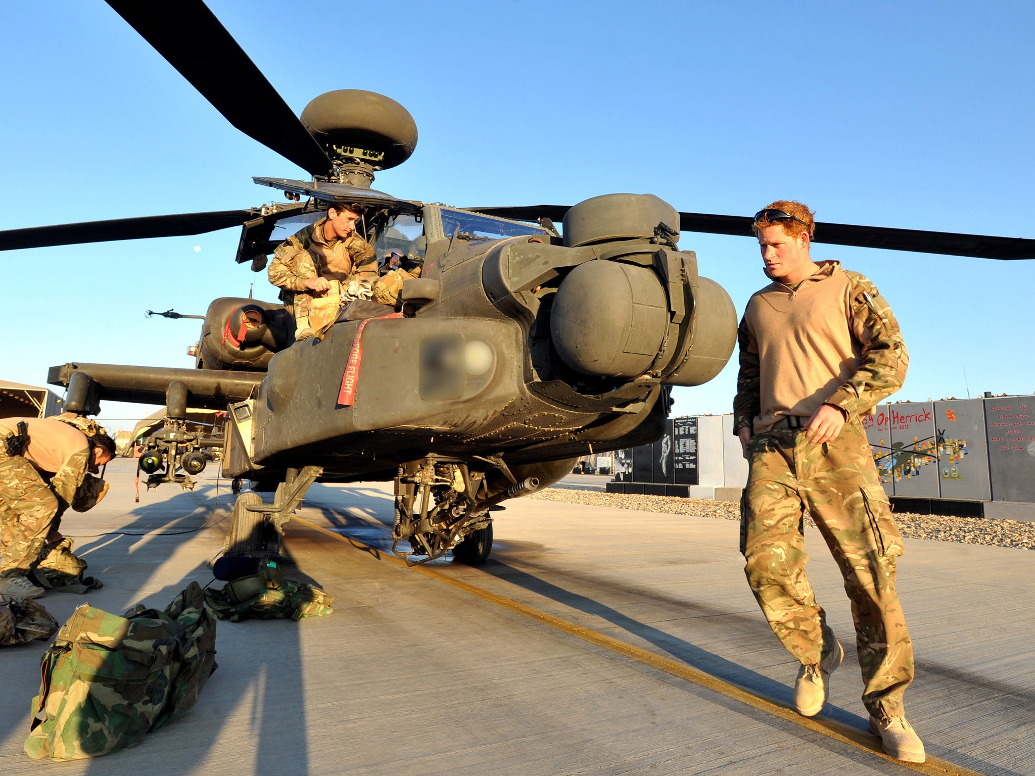 January 2013: Prince Harry carries out a pre-flight check of his Apache Helicopter after starting his 12 hour VHR (very high readiness) shift