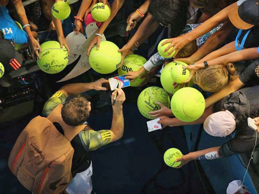 Andy Murray is besieged by autograph hunters at the Australian Open