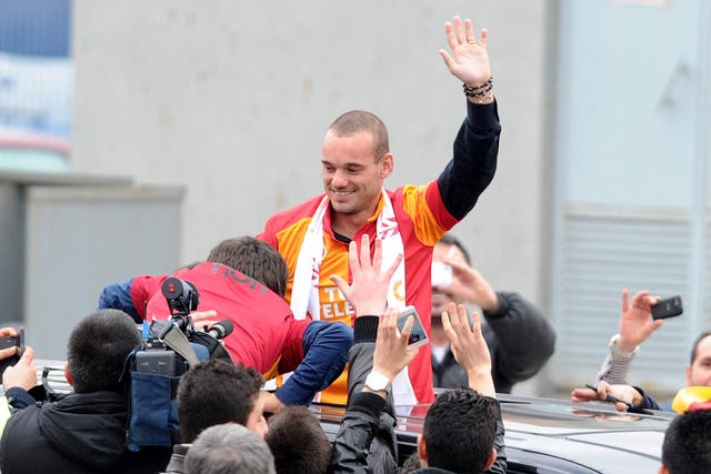 Wesley Sneijder is welcomed by Galatarasay supporters after his arrival at Ataturk airport 