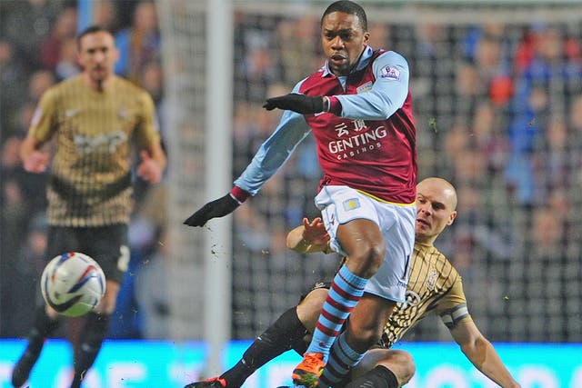 Gary Jones of Bradford City tackles Villa's Charles N'Zogbia