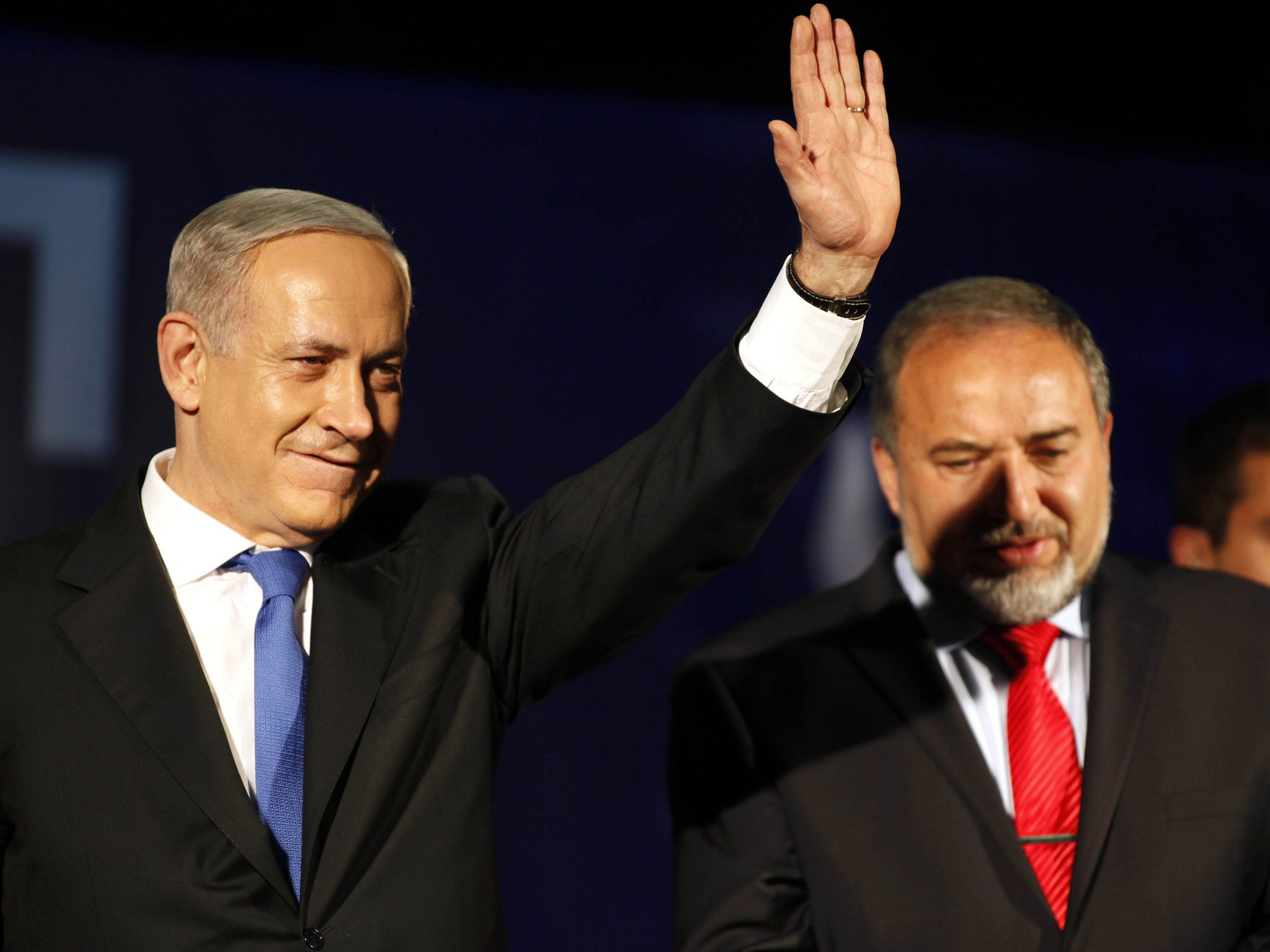 Israeli Prime Minister Benjamin Netanyahu (left) waves to supporters with Former Israel Minister for Foreign Affairs Avigdor Liberman