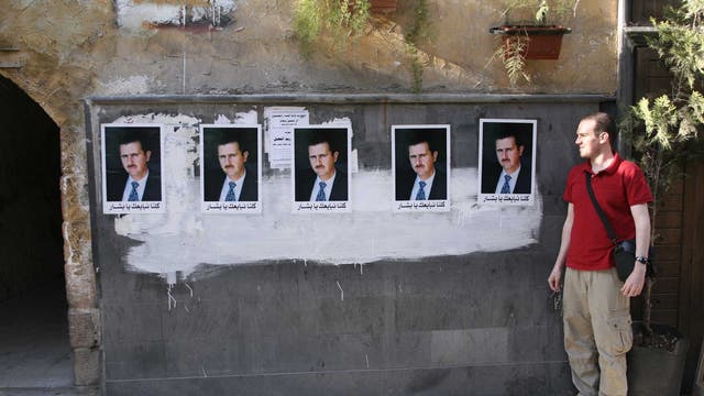 Rob Hastings with pro-Assad posters in Damascus