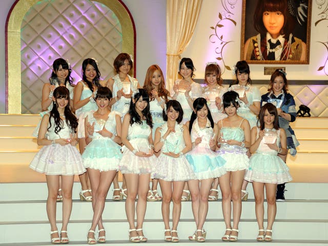 Tomomi Kasai (fourth from left, back row) is pictured with AKB48