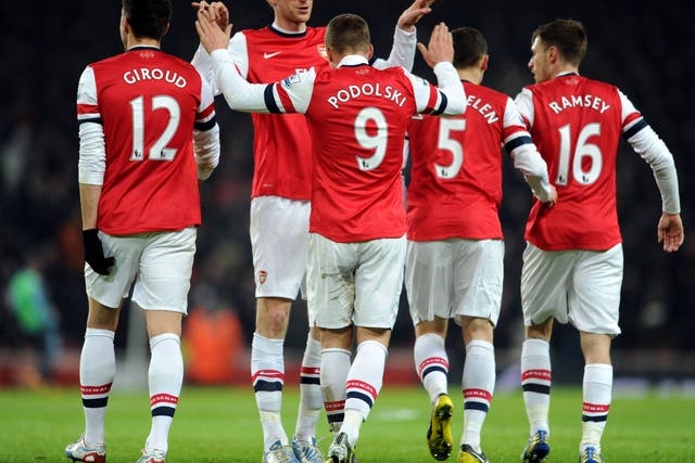 Lukas Podolski celebrates scoring Arsenal's first goal against West Ham