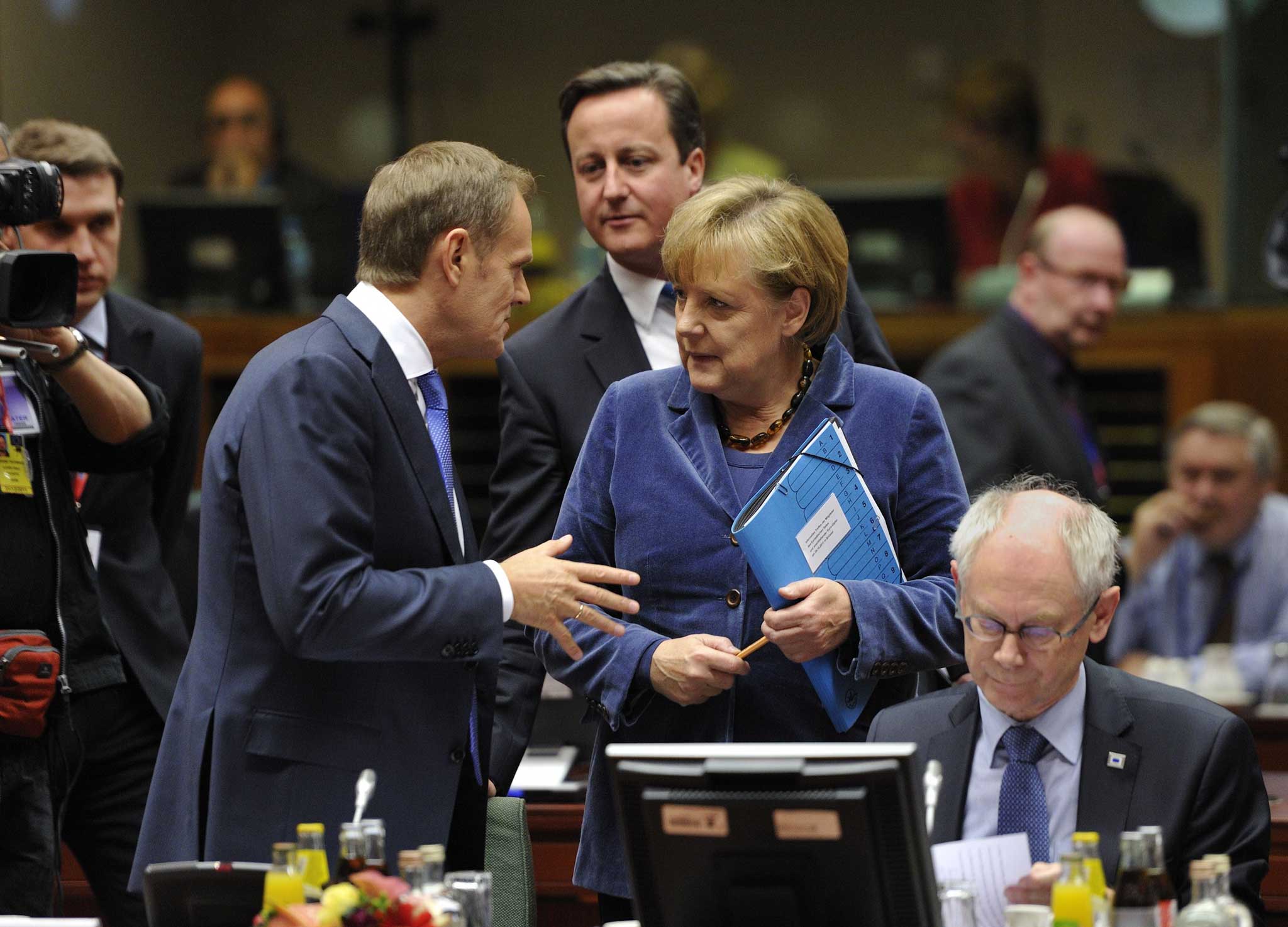 Outsider: Angela Merkel, Polish PM Donald Tusk - and David Cameron