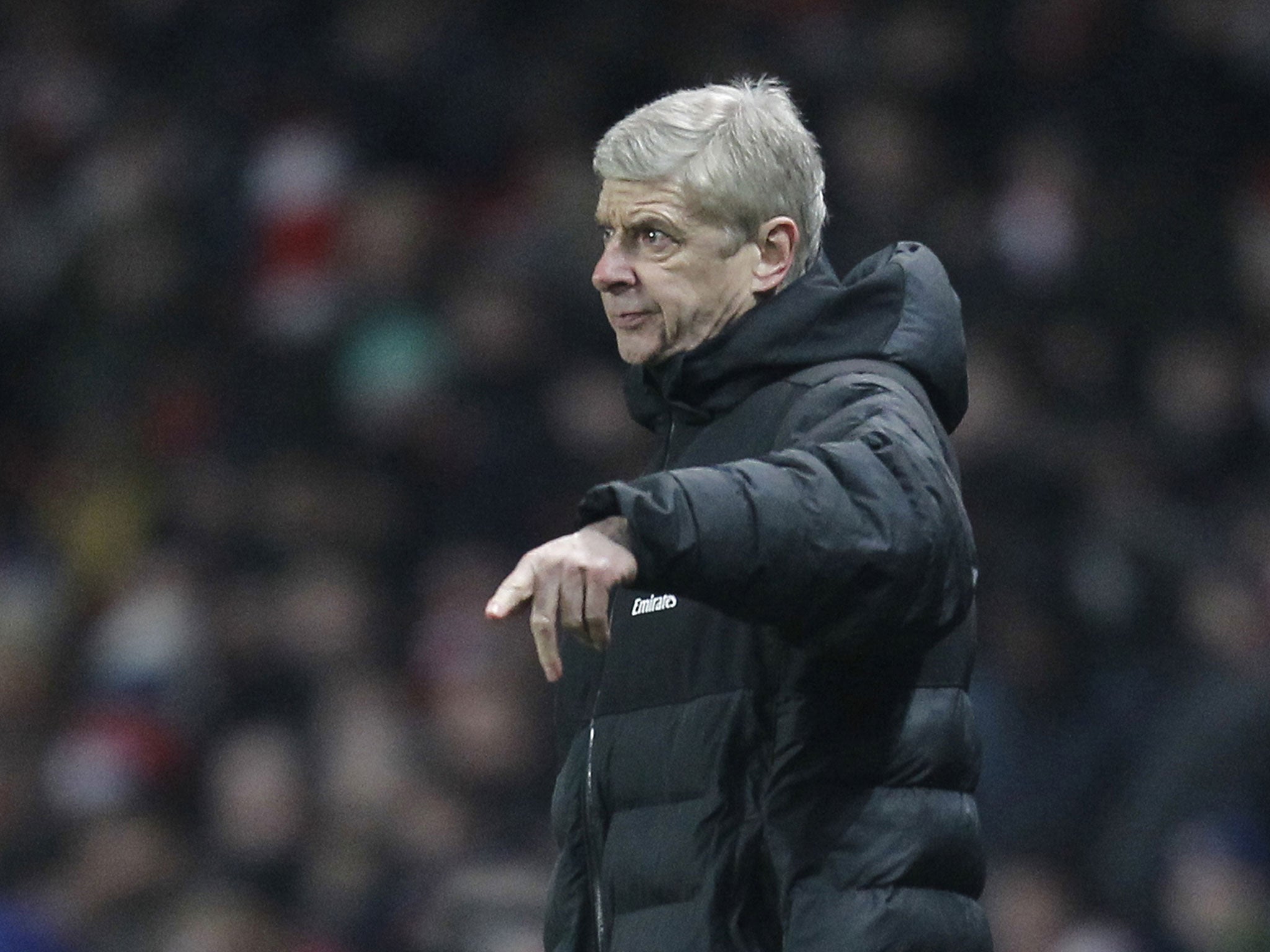 Arsenal's French Manager Arsene Wenger geatures from the touchline