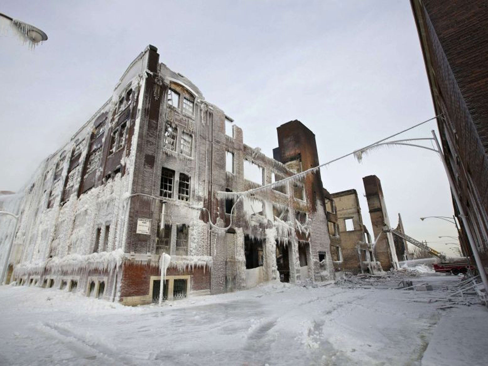 The ruins of a warehouse, still on fire, which started burning on Tuesday night are seen in Chicago January 24, 2013