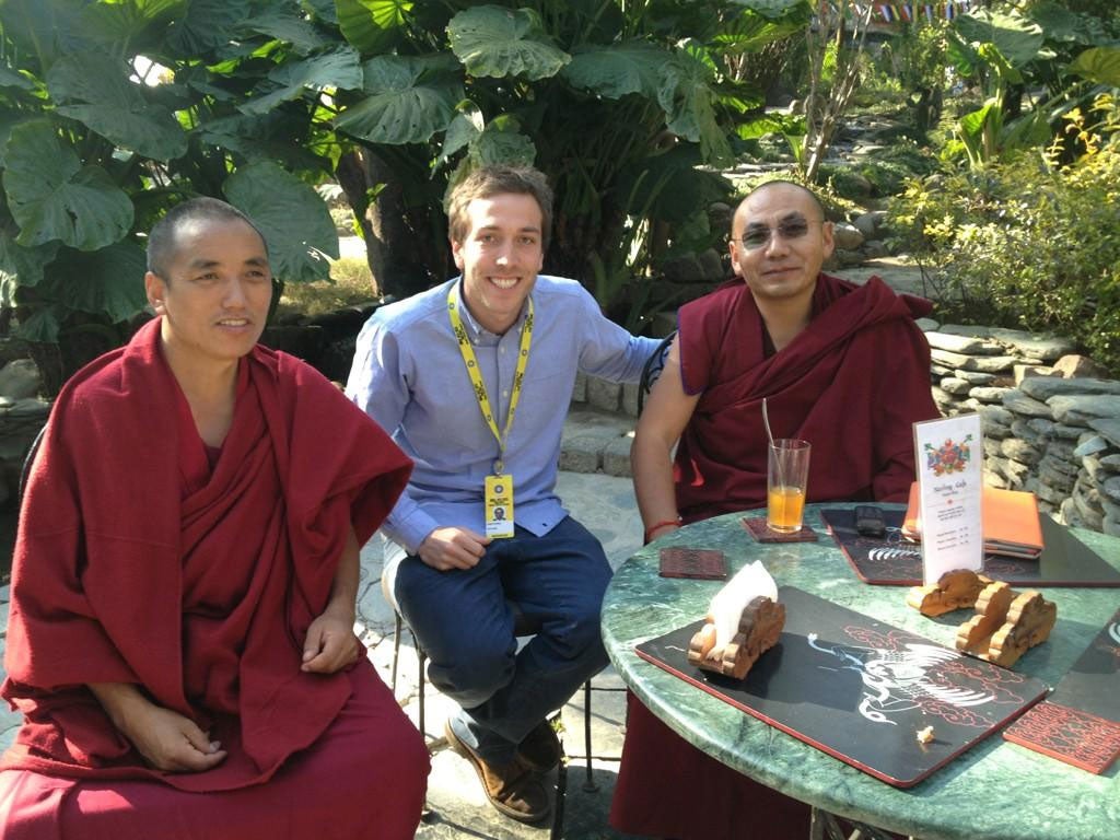 Tibetan monks mingle with members of the press
