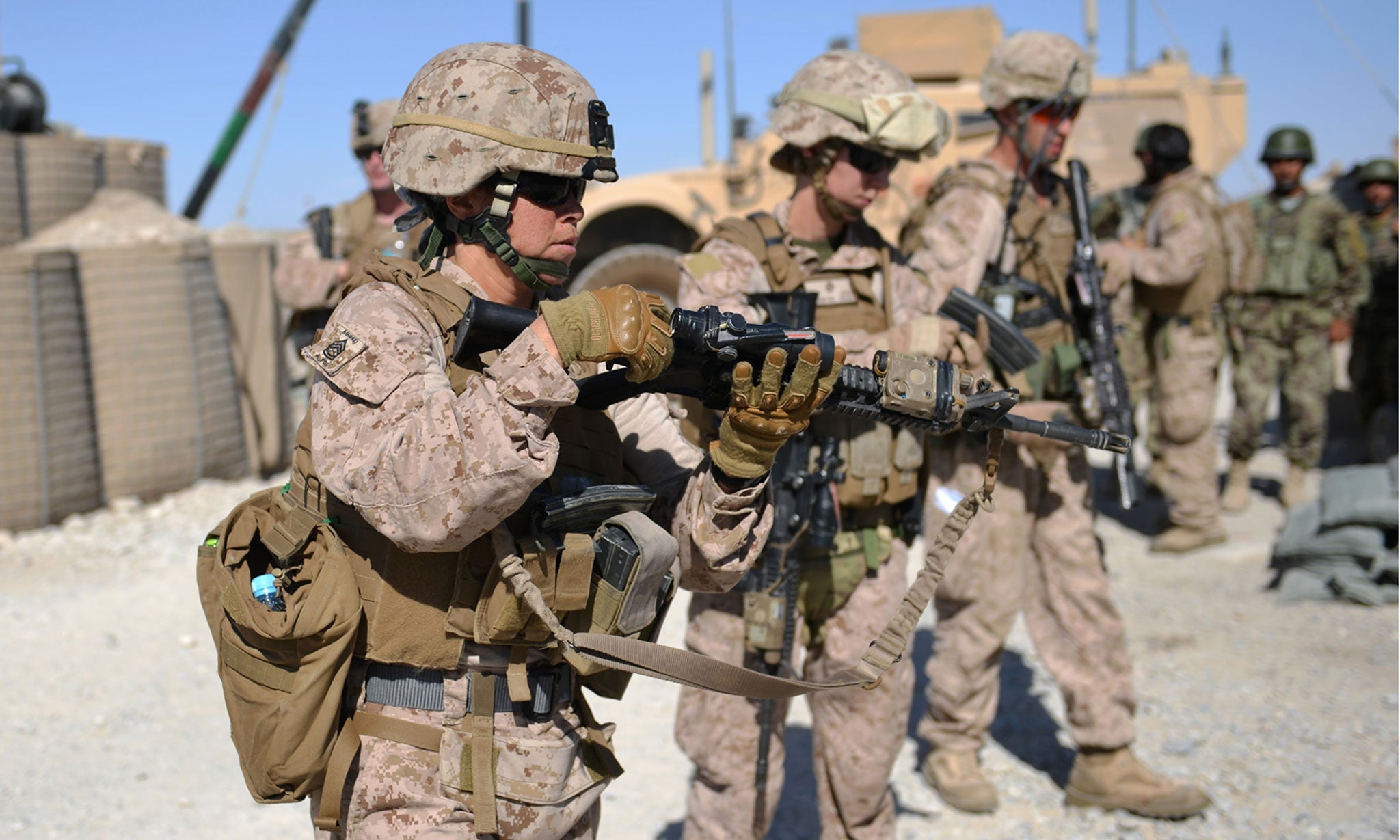 Members of a Female Engagement Team (FET) unload their M4 rifles after a patrol in Afghanistan