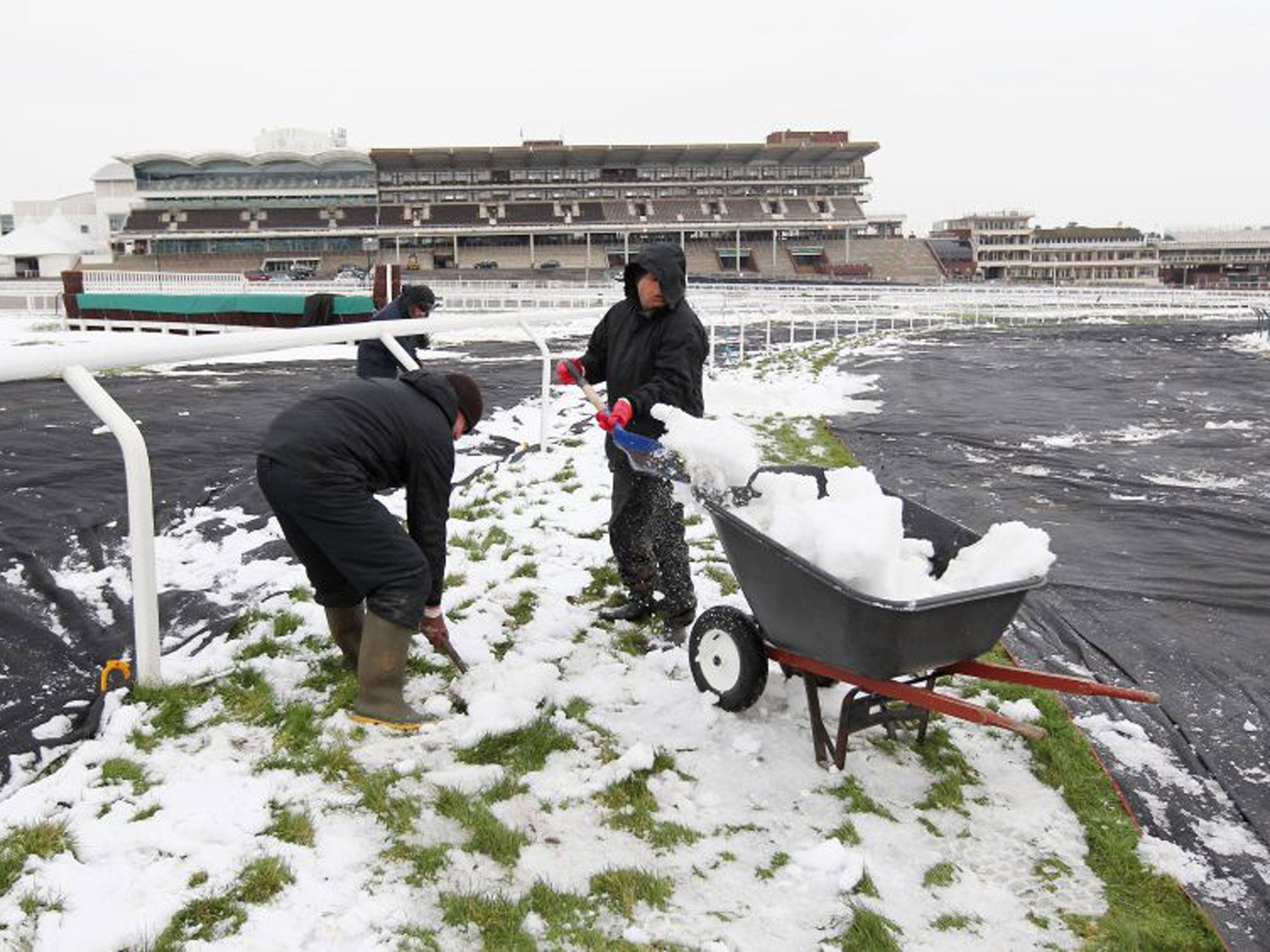 Cheltenham groundstaff clear snow in preparation for today’s fixture