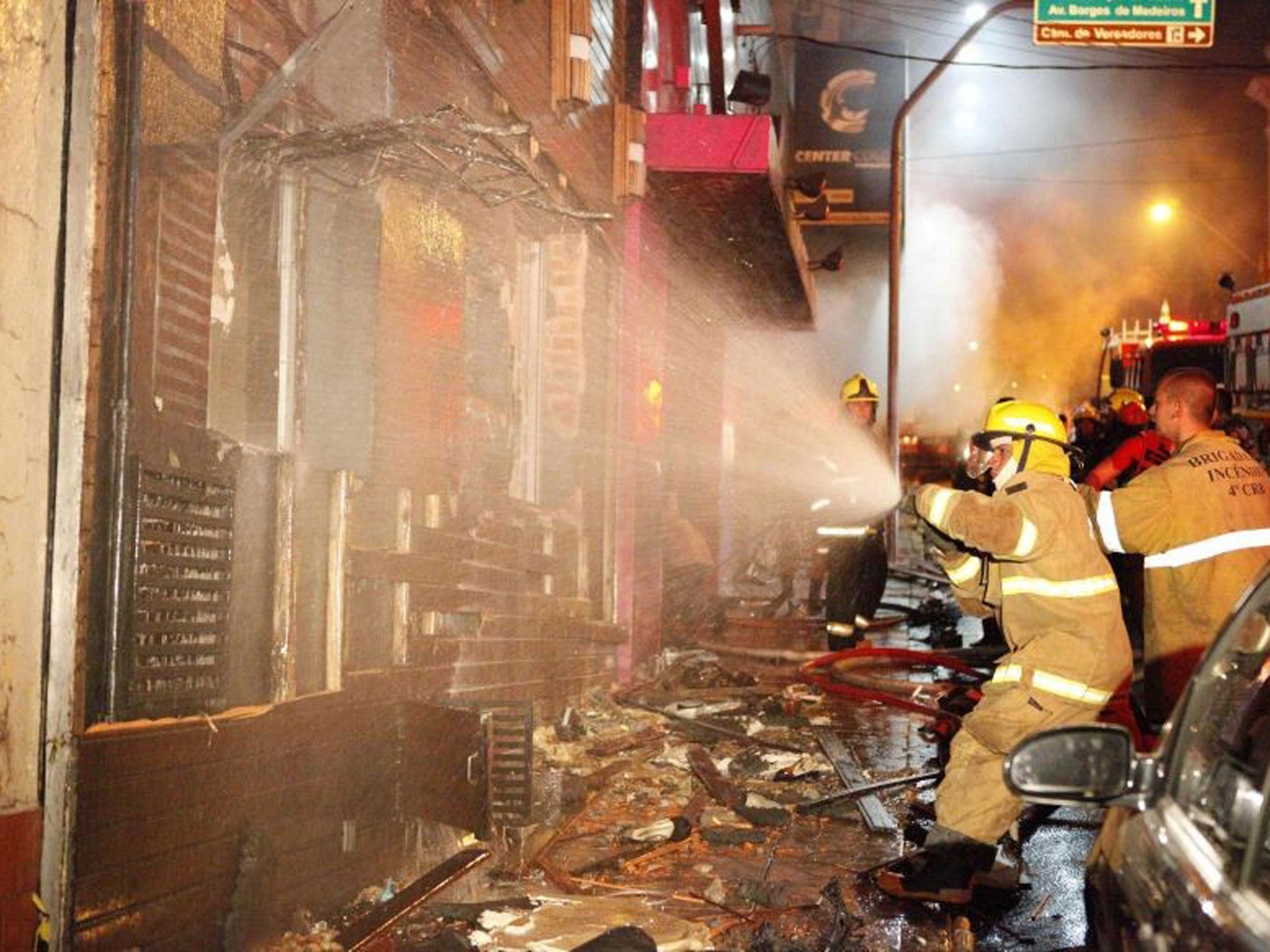 Fire-fighters try to extinguish a fire at Kiss nightclub in the southern city of Santa Maria. At least 200 people were killed